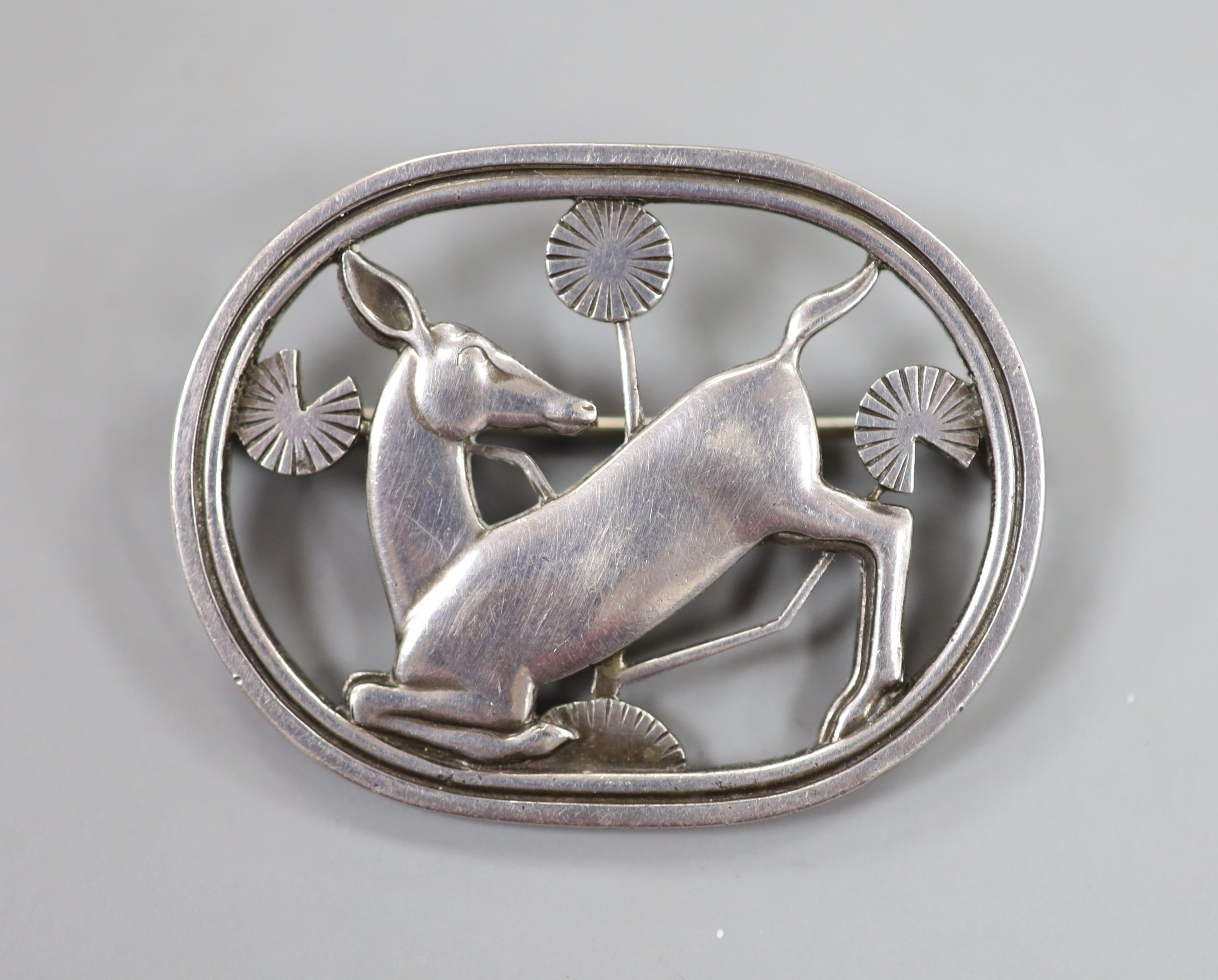 A Georg Jensen sterling kneeling deer oval brooch, no. 256, import marks for London, 1948, 44mm.